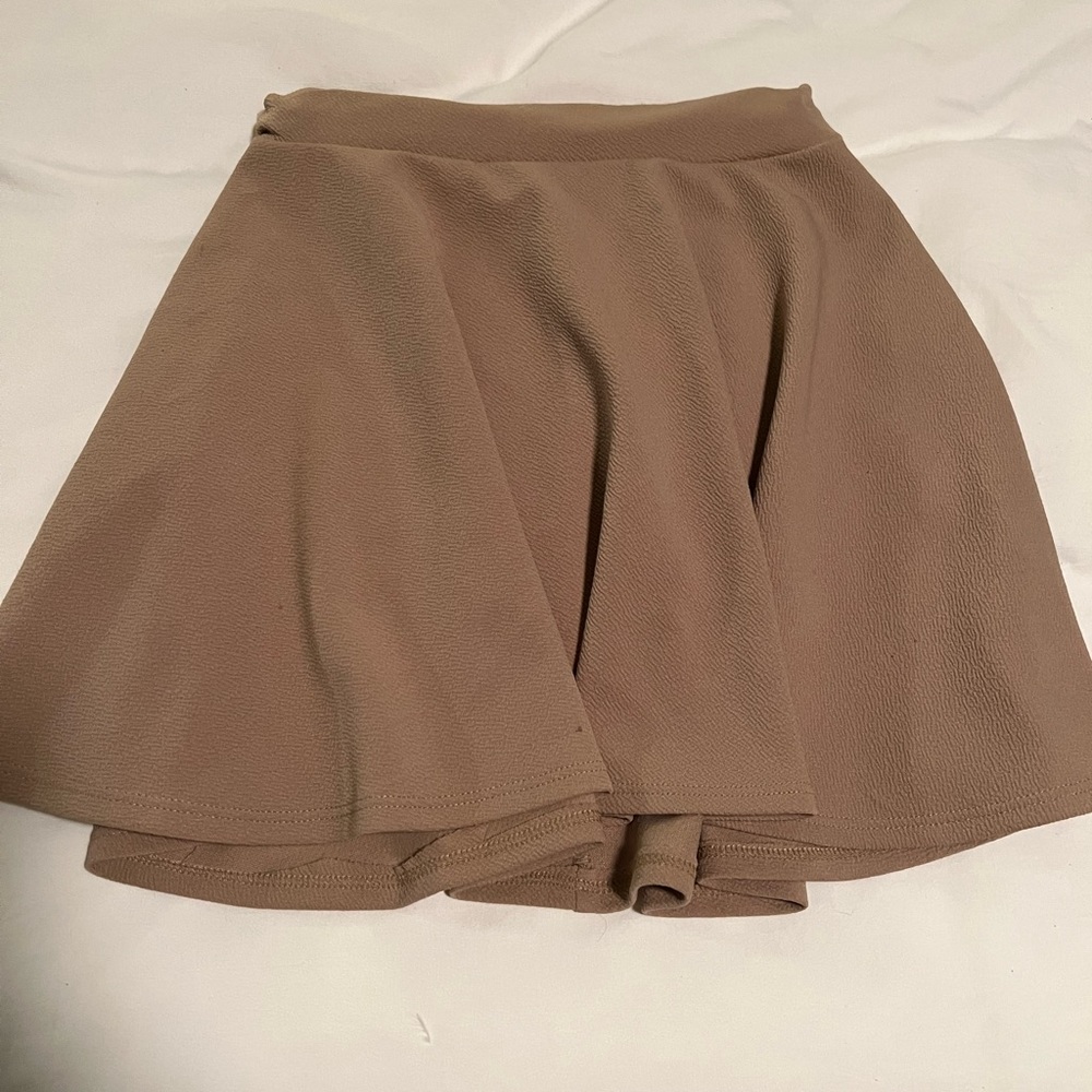 Tan skirt, black shorts